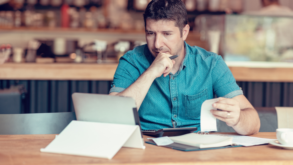 Concerned small business owner reviewing expenses