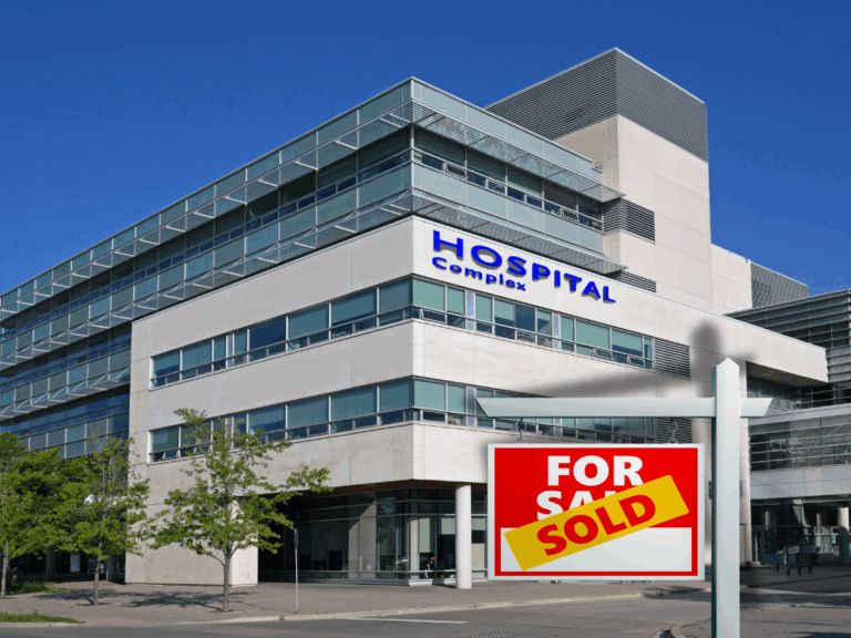 Hospital with a SOLD real estate sign in front of it