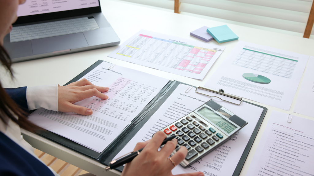 Accountant working with financial records and calculator