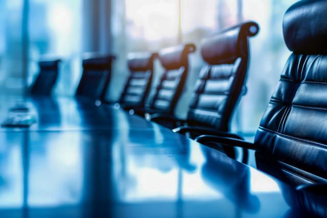 Empty seats at a conference table