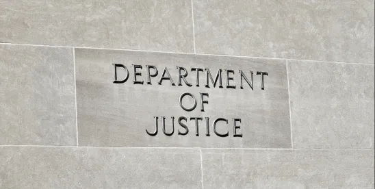 Exterior wall featuring sign that says Department of Justice