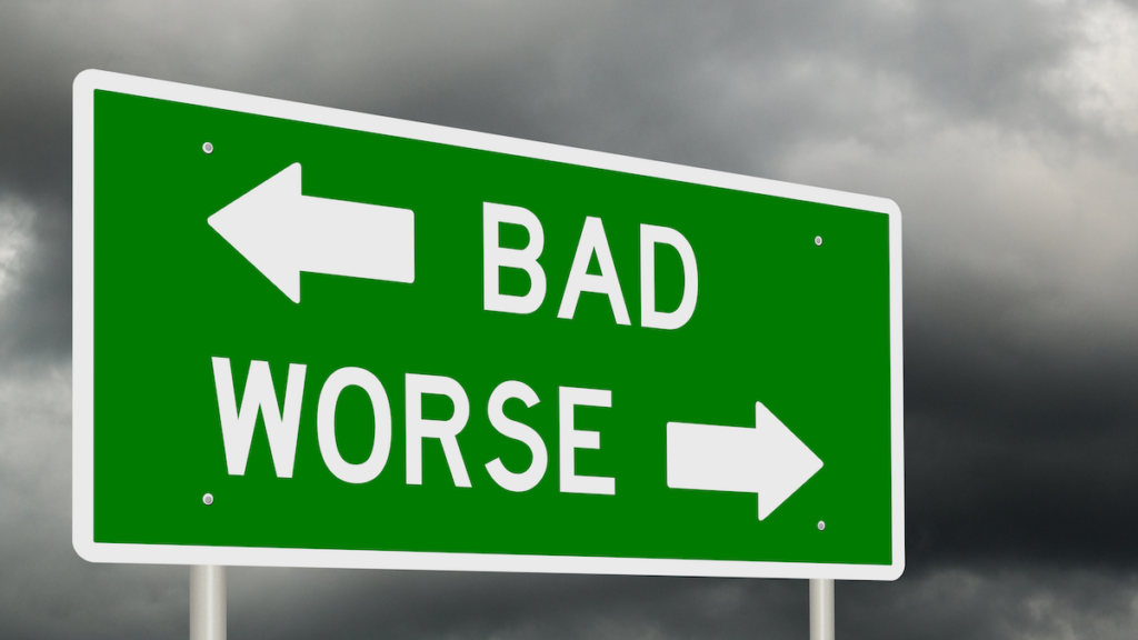 Green street sign with arrows pointing to BAD and WORSE